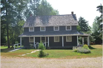 exterior image of an old building titled Spence Inn