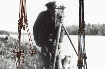 old photograph of surveyor in background and chain in foreground