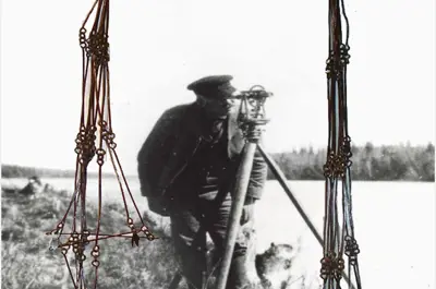 old photograph of surveyor in background and chain in foreground