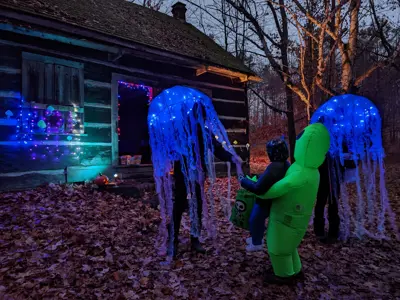 Child receiving candy during Halloween outside