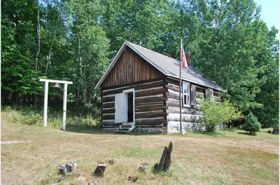 exterior image of school house with flag and school bell