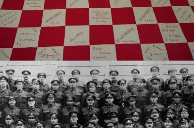 two images of quilt with embroidered names and image of soldiers